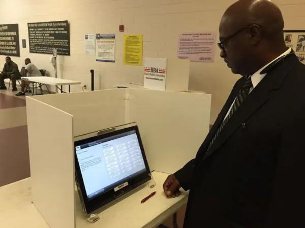 man voting using a voting machine from Honest Ballot