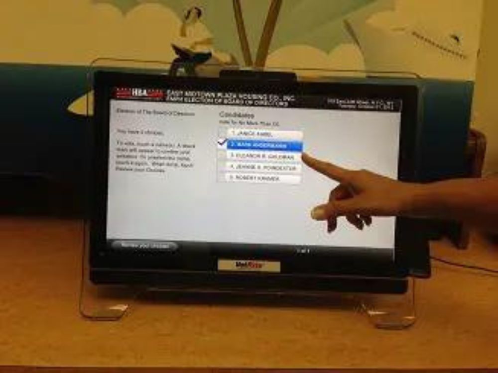 touchscreen voting machine being used to vote in an election